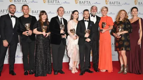 Getty Images (L to R) Matt Willis, Scott Mills, Suzy Lamb, Andrew Cartmell, Julia Sanina, Lee Smithurst, James O'Brien, Lisa McCormack, Nikki Parsons and Emma Willis, accepting the Live Event Coverage Award for 'Eurovision Song Contest 2023'.