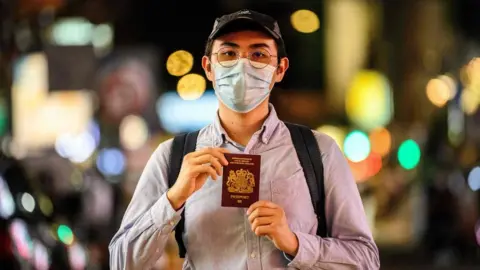 Getty Images A Hong Kong residents with their BNO passport