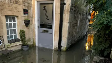 Tanya Kloppers The Courtyard Hair Salon surrounded by flood water