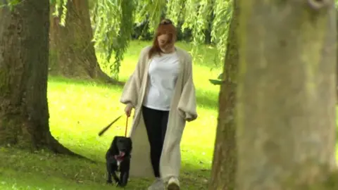 BBC Chloe Ambler walking with her dog