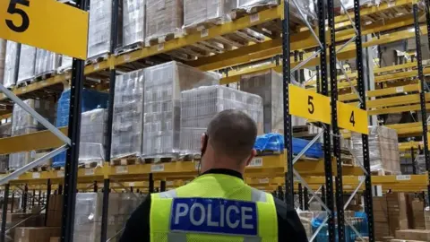 Northamptonshire Police Police officer in warehouse in Daventry