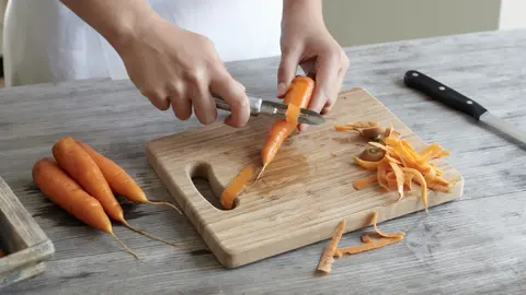 Getty Images Peeling carrots