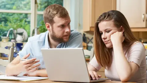 Getty Images Father helping his daughter with homework