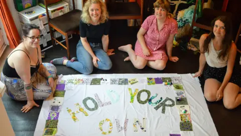 BBC Girl Gang Manchester with their "Hold Your Own" banner