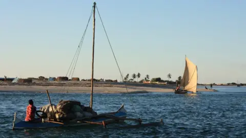 Tim Healy A man sails from Belo-sur-mer on a boat laden with cargo