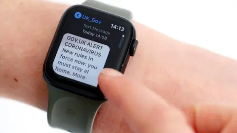 Getty Images Covid text alert on a smart watch