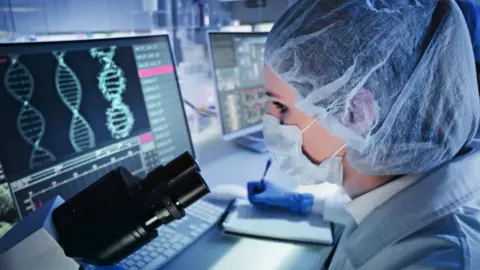 Getty Images Scientist looking at DNA