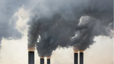 Getty Images Smoke billowing out of a chimney