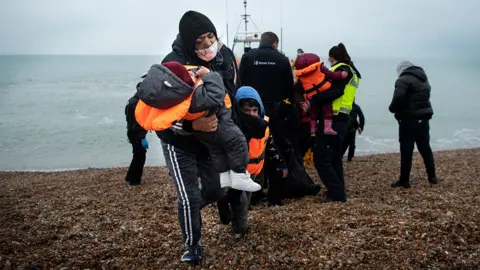 Getty Images Migrants on a beach in Dungeness, 24 November 2021