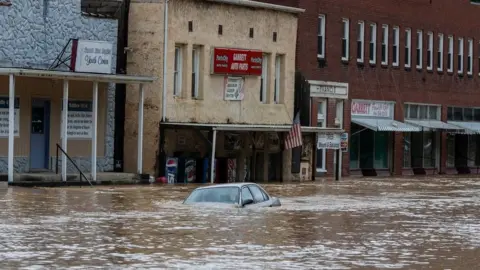 Reuters A car is submerged in flood waters on 28 July 2022.