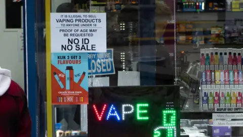 Getty Images Customers walk in a vape E-cigarette liquid shop