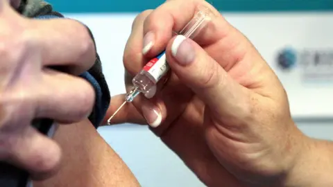 PA Media File photo of a person receiving a vaccination