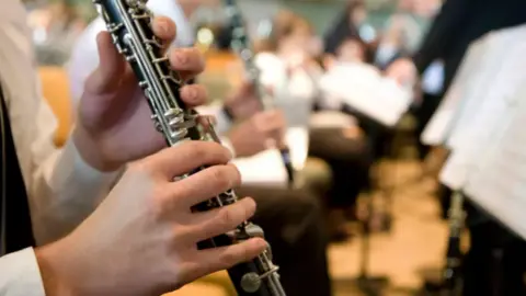 Getty Images Someone playing a clarinet