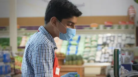 Getty Images young person a cash til