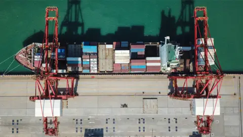 Getty Images Aerial photograph of a cargo ship berthing at a port in Lianyungang in China's eastern Jiangsu province.
