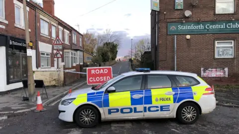 Police car in front of a closed road