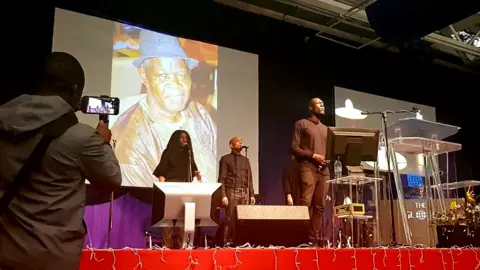 @AkdotIk/Twitter Stormzy performs at the funeral