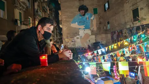 Getty Images People gather at the top of the Quartieri Spagnoli in Naples