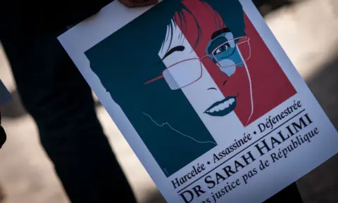 Getty Images "Harassed, murdered, thrown out of a window," the placard reads