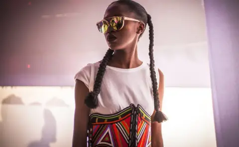 Marta Moreiras A model wearing a colourful and handcrafted accessory by fashion label Moyo By Bibi during Dakar Fashion Week in Dakar, Senegal