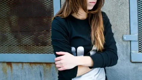 Getty Images woman standing with her arms crossed