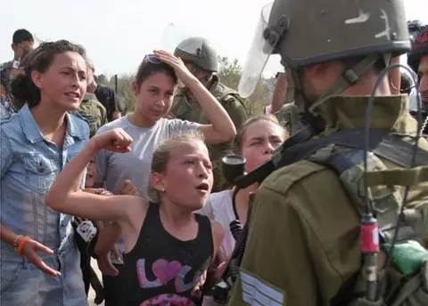 AFP Ahed Tamimi gesturing as if to punch an Israeli soldier (02/11/12)