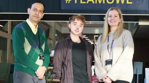 UWE Bristol Puspa Pant, Brodie Goodall and Debbie Hubbard. They are standing in a line and smiling at the camera.