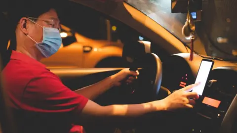 Getty Images woman driver in mask