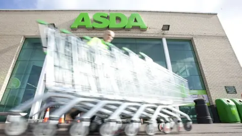 Newscast Asda employee collects trolleys