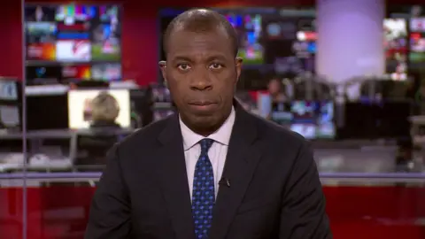 Clive Myrie presenting the news