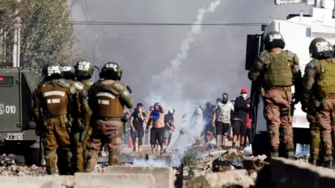 EPA People clash with police during a protest for lack of food