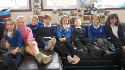 XTND XTND after-school club pupils sitting on a sofa