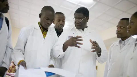 AFP Denis Mukwege talks to staff and students during a round at the ward for recovering patients on November 2, 2007 in Bukavu