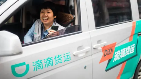 Getty Images Didi on-demand delivery driver in vehicle.