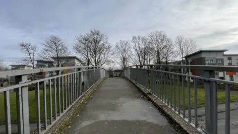 Ben Schofield/BBC A footbridge over the Queensway road in Wellingborough
