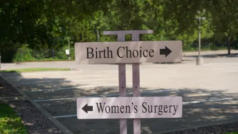 Chelsea Bailey, BBC News A sign outside an abortion clinic in Dallas, Texas.