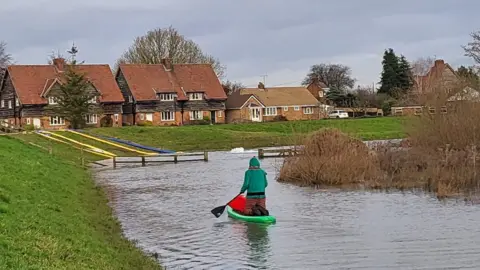 Amy Pulling Oscar on his paddleboard