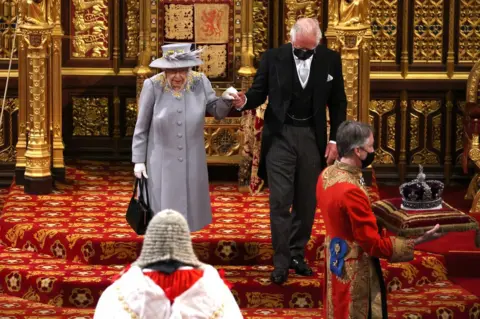 PA Media Queen Elizabeth II leaves the House of Lords after delivering the Queen's Speech