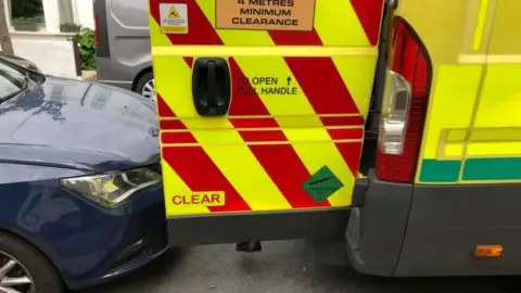 East of England Ambulance Service Car parked behind ambulance