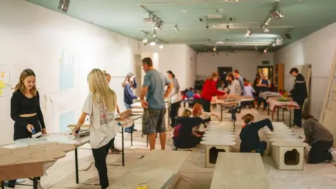 Mark Grey Students painting the super shrine