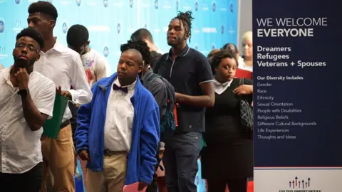 AFP/Getty Job seekers arrive at the Walter E. Washington Convention Center for The Opportunity Hiring Fair in Washington, DC, on September 20, 2017
