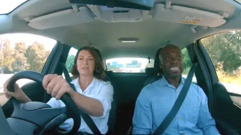 National Highways Suzi Perry and Ortis Deley in a car on a Smart Motorway