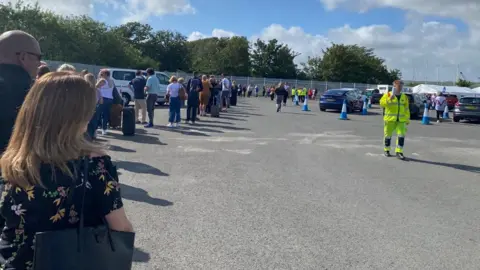 Andy Tucker Queues for pre-embarkation Covid tests in Portsmouth