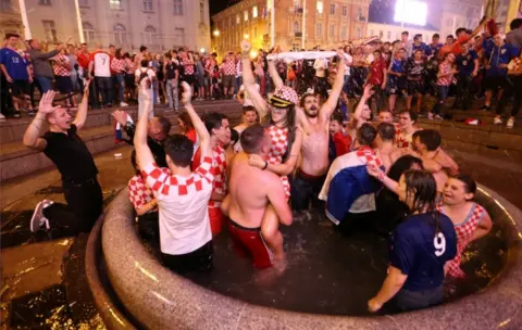 Reuters Croatia's fans celebrate in Zagreb after Croatia beat England in semi-final of the 2018 World Cup