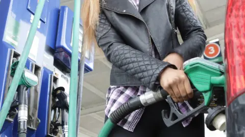 Getty Images Woman at petrol pump