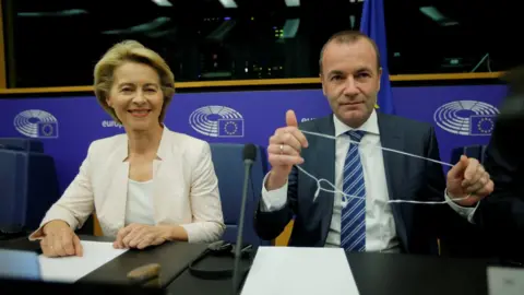 Reuters Ursula von der Leyen, who has been nominated as European Commission President, sits next to EU Parliament's political group European People's Party (EPP) president Manfred Weber at the European Parliament