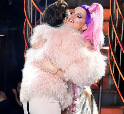 Getty Images Courtney Act hugging Emma Willis