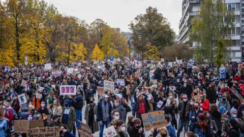 Omar Marques via Getty Images People shout slogans and hold banners as they participate in a national strike during the seventh day of protests against the Constitutional Court ruling