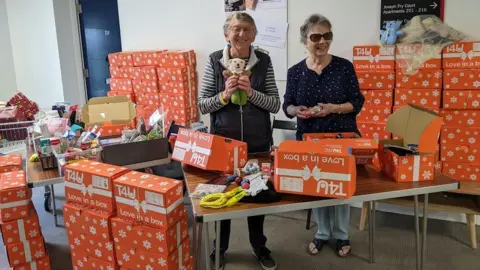 BBC Piles of filled boxes at Stoke Gifford retirement village