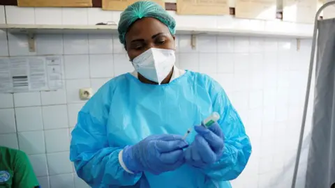 Reuters A nurse prepares a dose of the AstraZeneca coronavirus disease (COVID-19) vaccine at the Ngaliema Clinic in Kinshasa